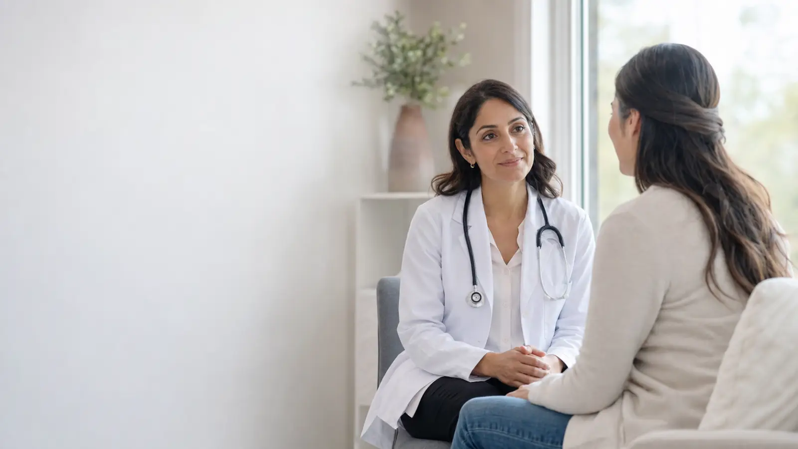 Doctor warmly speaking with a patient